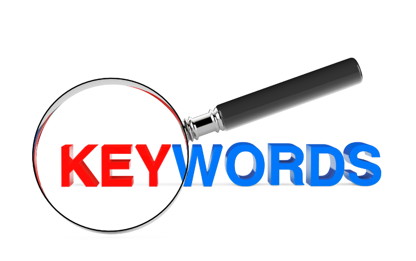 Magnifying glass highlighting the word 'KEYWORDS,' representing search engine optimization and eCommerce SEO strategies.